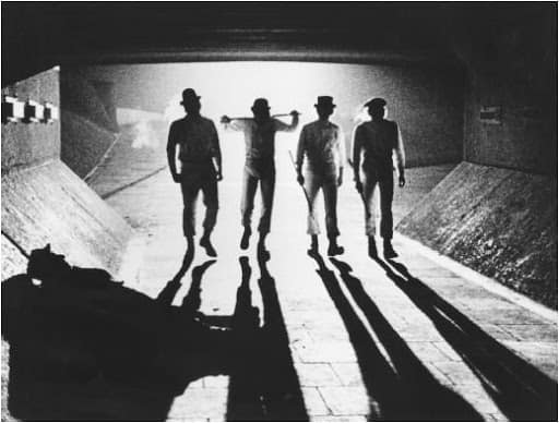 four man standing and their shadows